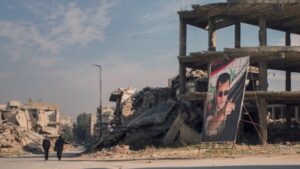 صورة بشار الأسد بين الدمار